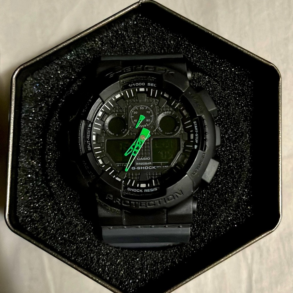 Black G-shock with green hands